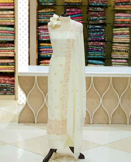 White colour georgette salwar set featuring gold zari buttas on body, floral embroidery and scalp work on dupatta, paired with matching bottom.