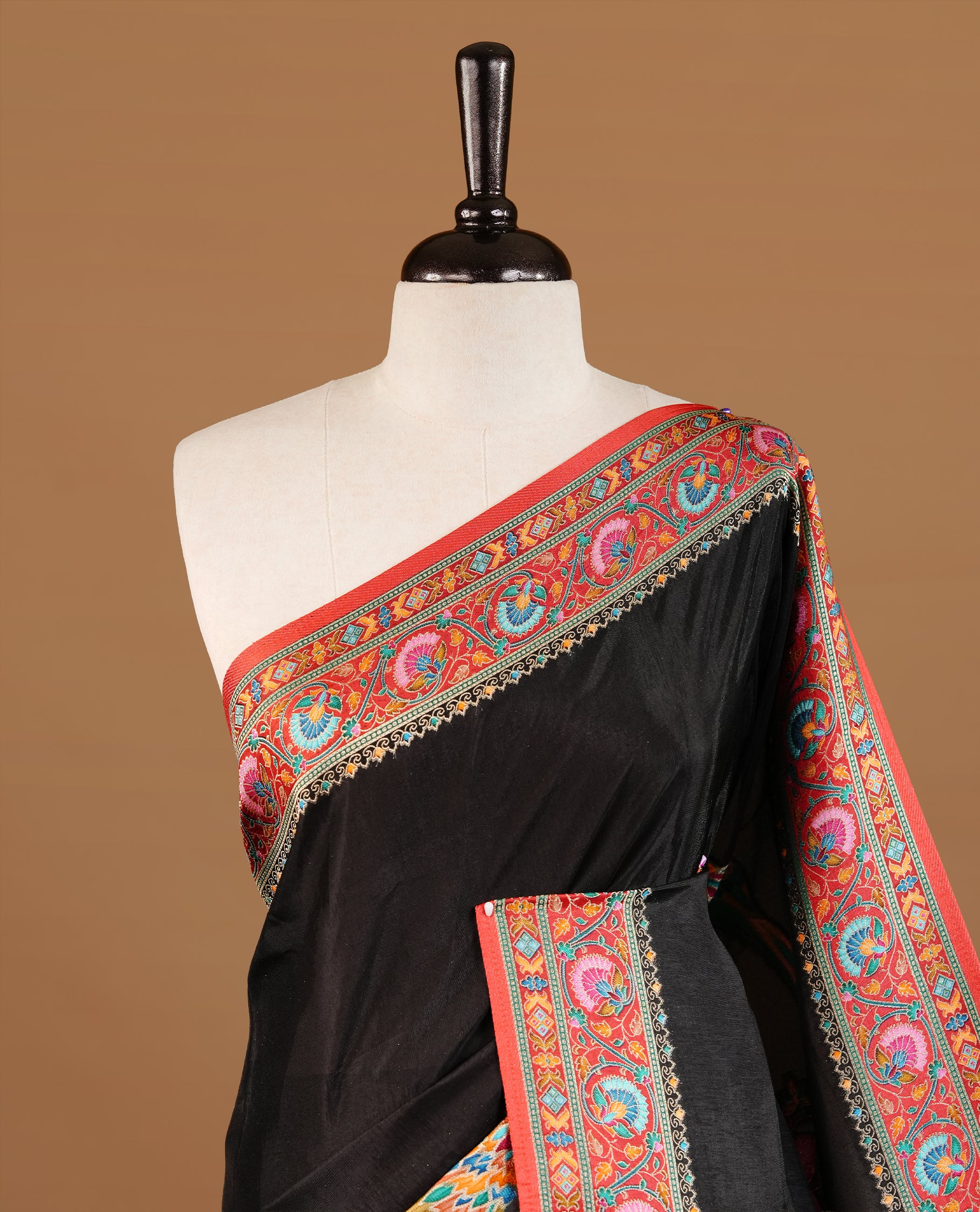Black colour Pashmina Saree featuring a plain body, a multicolour floral woven border, a floral woven pallu, paired with a matching blouse.