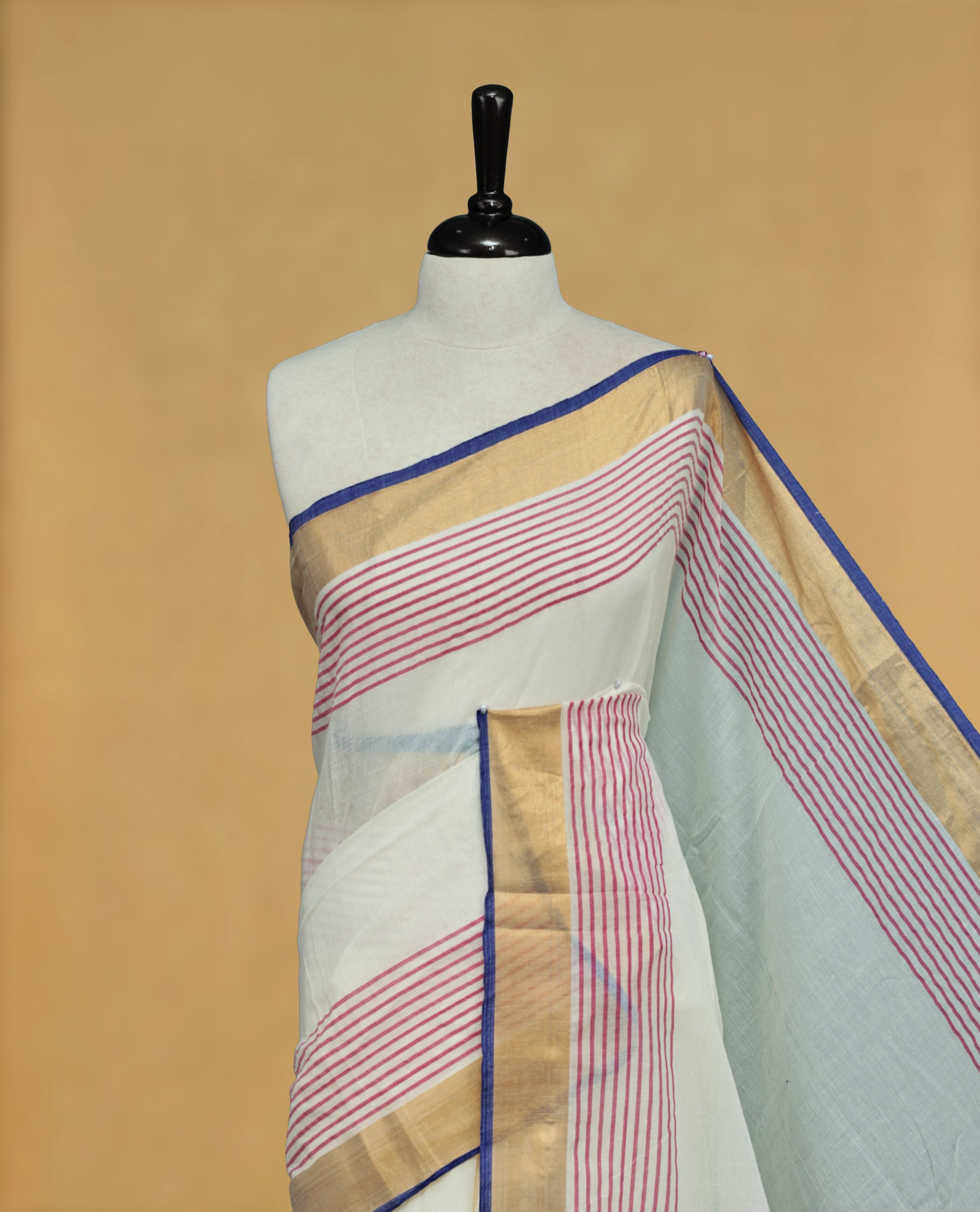 Off White Colour Mul Cotton Saree featuring Elegant Plain Body, Contrast Gold, Pink & blue Border and Tassels Onam inspired charm.
