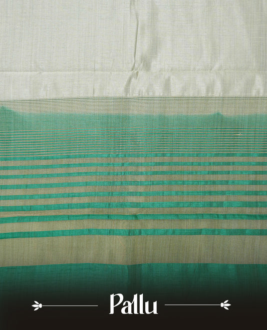 Light gold tussar saree featuring Elegant plain body, complemented by contrast green colour with Gold zari Floral kodi with Elephant Pattern border, comes with matching blouse piece.