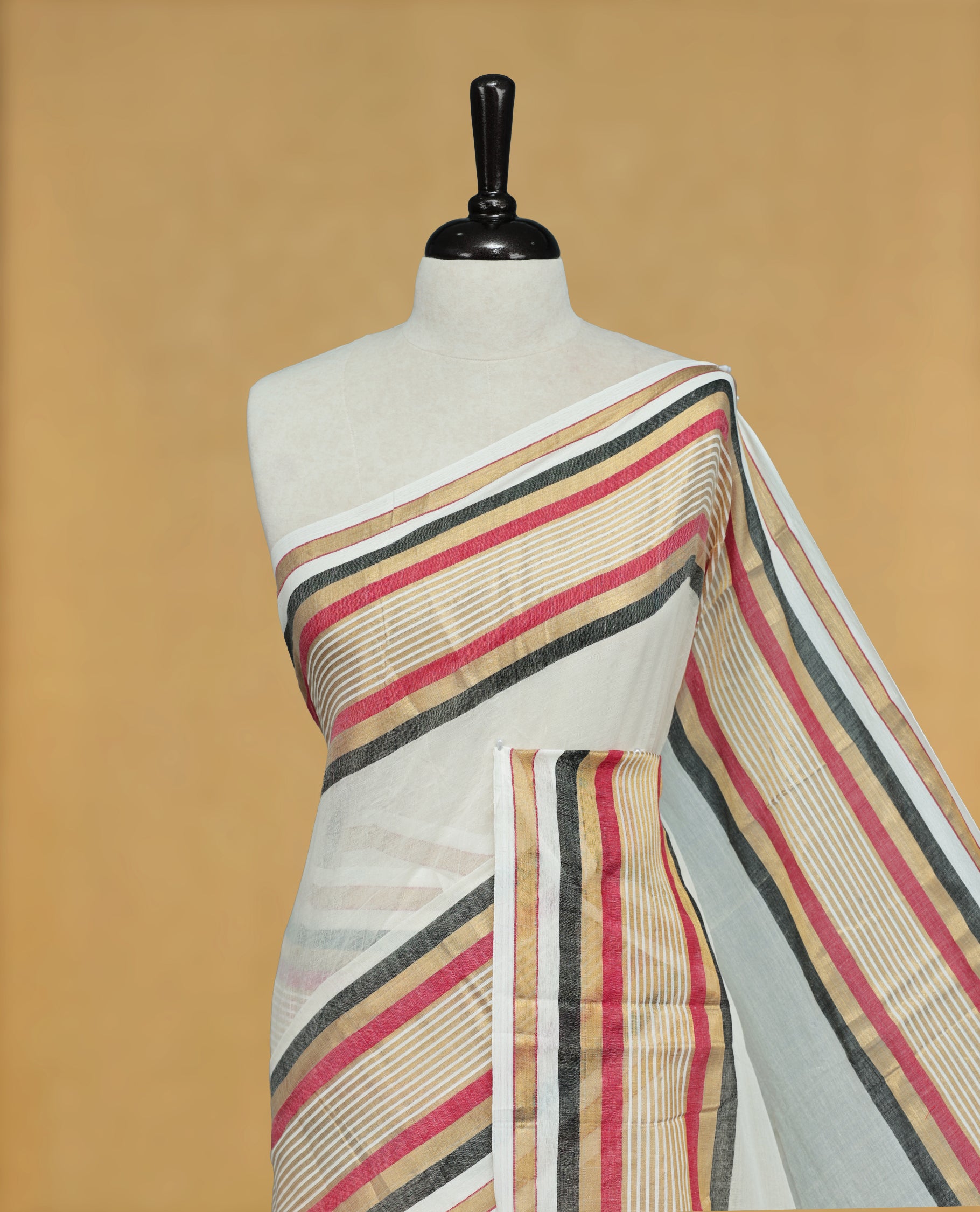 Off White Colour Mul Cotton Saree featuring Elegant Plain Body, Contrast Gold, Red & black Border and Tassels Onam inspired charm.