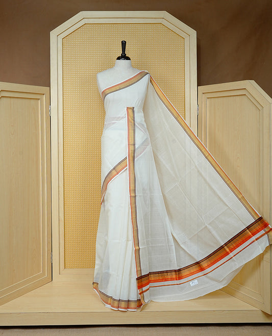 Cream colour Cotton kerala saree featuring Classy Plain body, complemented by Gold with Brown  & Orange zari border & Pallu, paired with matching blouse piece.