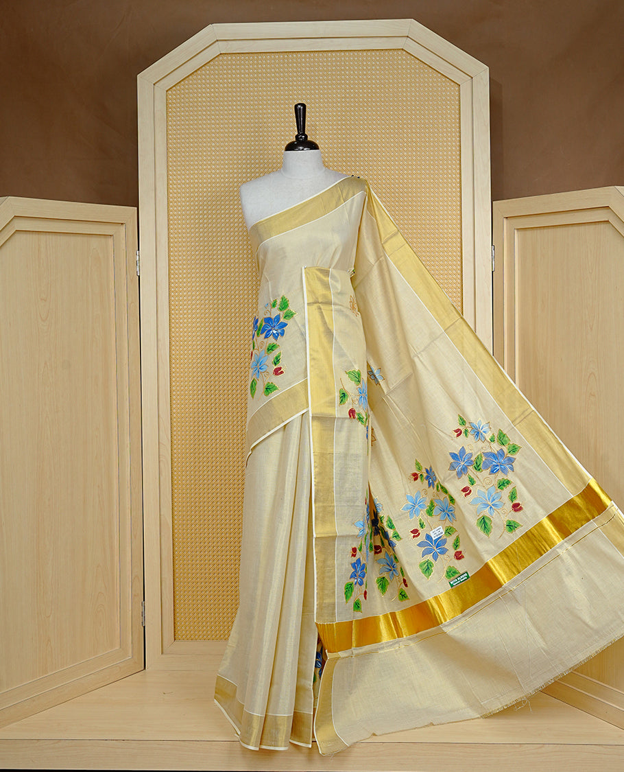 Cream colour Tissue kerala saree featuring Embroidery buttas on body, complemented by Floral thread work with Print & kasavu kara, comes with matching blouse piece.