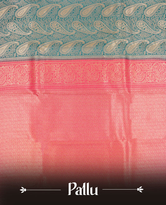 Blue colour semi silk brocade saree featuring intricate Gold Floral kodi & leaf patterns across the body, complemented by a contrast Magenta colour woven border and pallu, paired with a matching blouse.