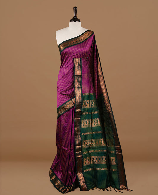 Purple colour kalyani cotton saree featuring gold zari check pattern on body, highlighting contrast green colour with Antique gold zari border, paired with matching blouse piece.