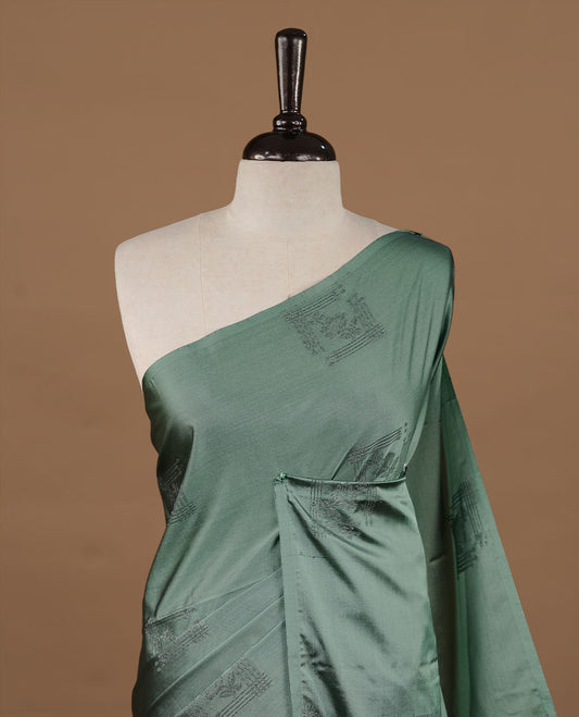 Pastel green colour soft silk saree features a sleek borderless design with intricate antique zari motifs, flowing into a striking contrast purple pallu and a matching blouse piece.