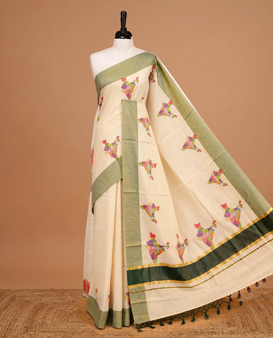 Cream Colour Kerala Saree Featuring  Plain Body ,Complemented By A Green Zari With Indian Map Border ,Enhance By A  Gold Zari & Green Pallu ,Paired With A Matching Blouse Piece.