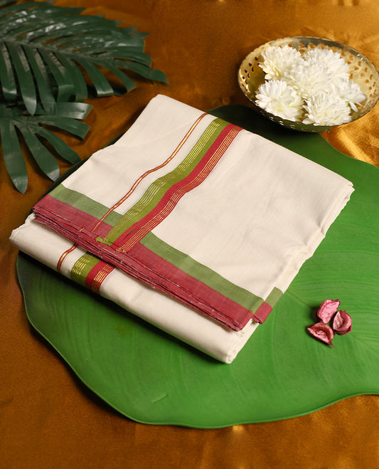 Ivory pure handloom cotton double dhoti designed with a dual tone border in red and green, accented with subtle golden zari lines, offering breathable comfort and traditional elegance for festivals, rituals, and cultural occasions.