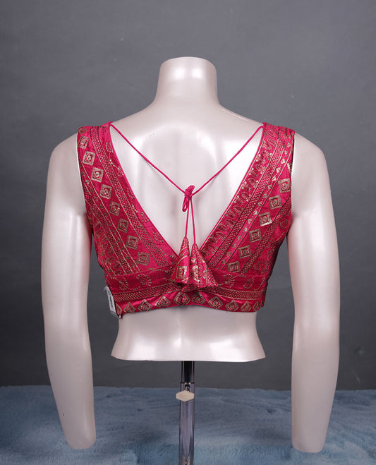 Pink colour embroidered sleeveless blouse with intricate geometric motifs, deep V neckline, and tie-up back detailing for a chic finish.