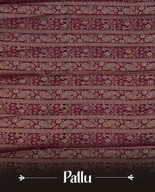 Burgundy colour semi Tussar silk saree featuring an elegant plain body, complemented by a self colour border adorned with traditional gold zari floral kodi patterns. Comes paired with a matching blouse piece.