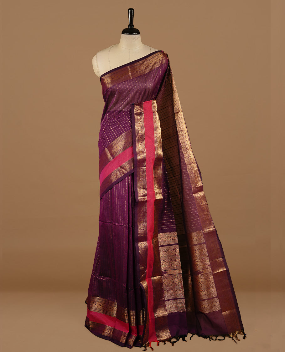 Purple colour chettinad cotton saree featuring gold zari motifs on body, complemented by magenta colour with zari border, paired with matching blouse piece.