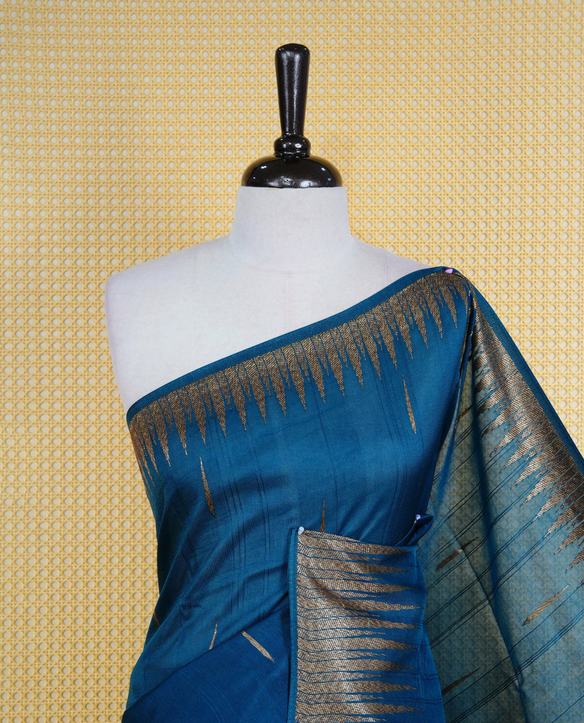 Teal colour semi banaras tussar georgette saree featuring gold zari pattern on body, finished with gold zari temple border and paired with matching blouse piece.