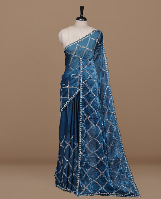 Blue colour designer saree featuring Sequins & cut beats worked body, cut beat worked border, paired with matching unstitched blouse.