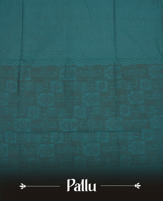 Dark Teal Green colour poly cotton saree with black zigzag line pattern on the body, paired with a matching pallu featuring black chevron lines and panelled floral‑paisley design, and a coordinated all‑over floral paisley patch‑style printed blouse piece.