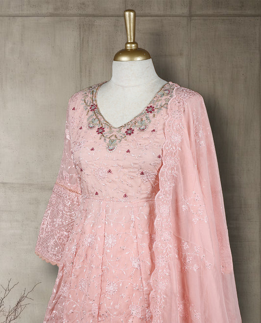 Baby pink colour salwar from TWARA, featuring a delicate embroidered V neck with floral thread work, all over chikankari style embroidery on the top, paired with a matching bottom and an elegant sheer dupatta.