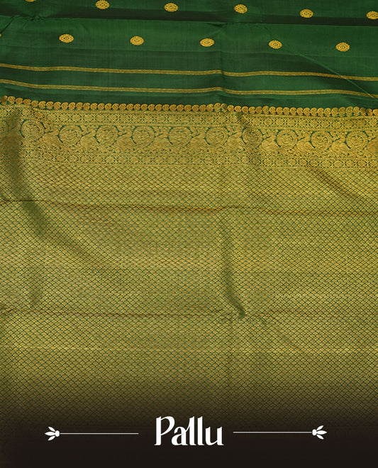 Bottle green pure traditional Kancheepuram silk saree adorned with gold zari chakra motifs across the body, featuring elegant gold zari traditional borders, beautifully paired with a matching blouse piece.