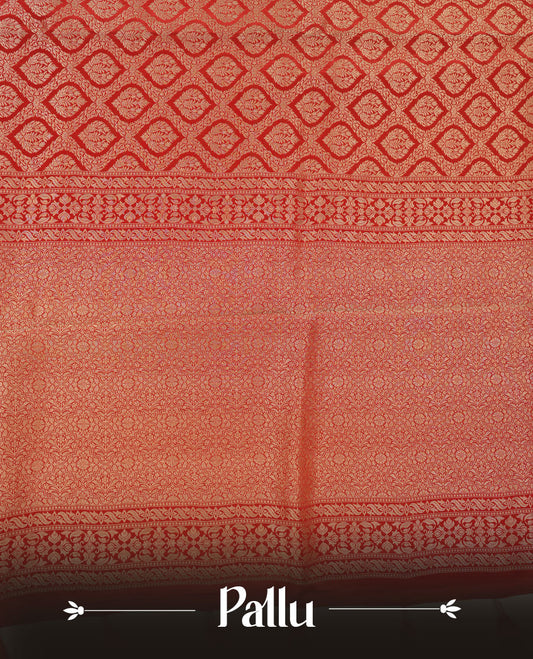 Red colour banaras satin crepe saree featuring gold zari pattern across body, with self colour border with gold zari pattern and paired with matching blouse.