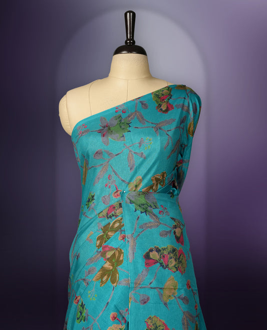 Turquoise Blue colour saree enhanced with a vibrant olive green,maroon and grey colour floral prints on body & pallu, and  comes with a matching blouse.