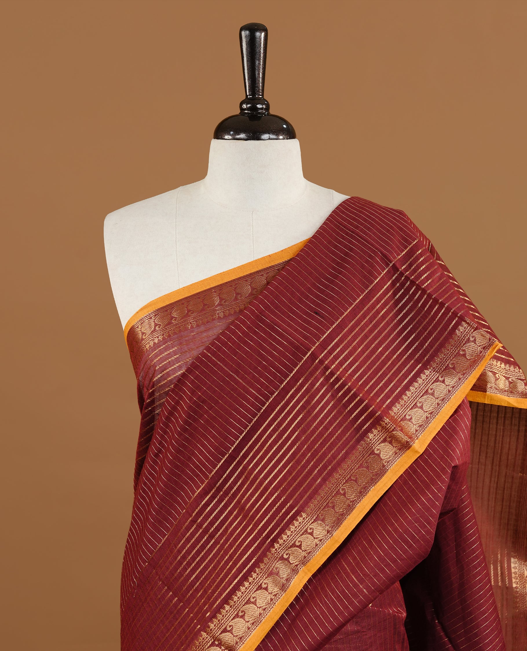 Maroon colour Chettinad cotton saree featuring gold zari stripes on body , complemented by contrast Magenta colour with zari border, comes with matching blouse piece.