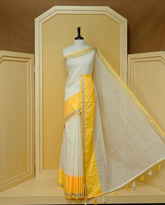 Cream colour Cotton kerala Saree featuring Plain body, Big yellow & gold kasavu border, comes with matching blouse piece.