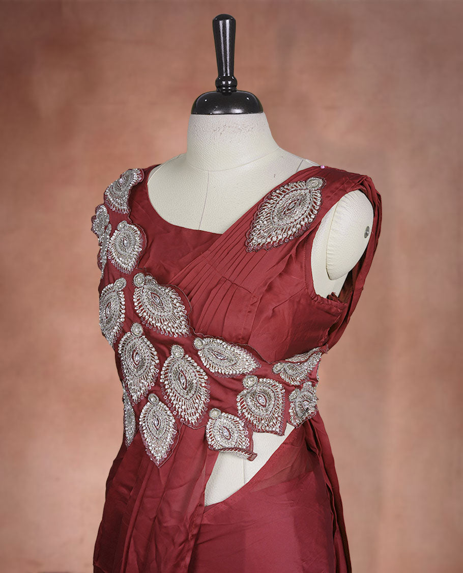 Deep Red colour ready to wear saree featuring bold silver applique embroidery on the drape, paired with a sculpted matching blouse.