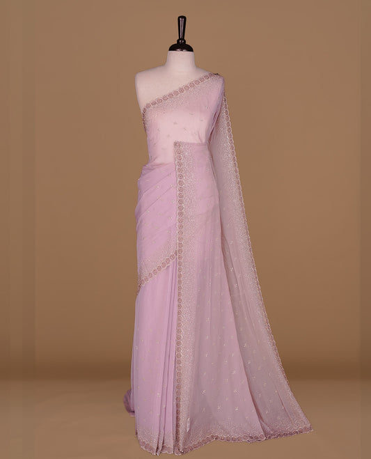 Lavender colour designer saree featuring gold & white stone worked body and border, paired with matching blouse piece.