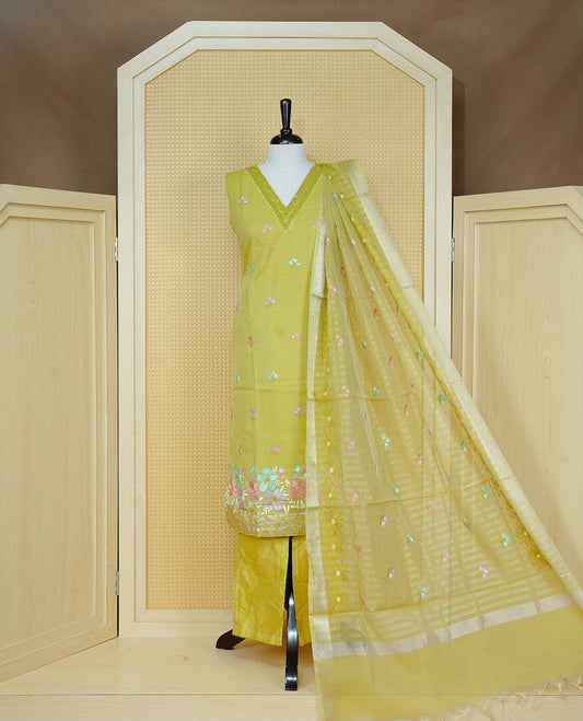 Lemon green colour churidar set with a beaded V-neckline, pastel floral buti embroidery and floral hem detailing, paired with a matching embroidered bordered dupatta and solid pants.