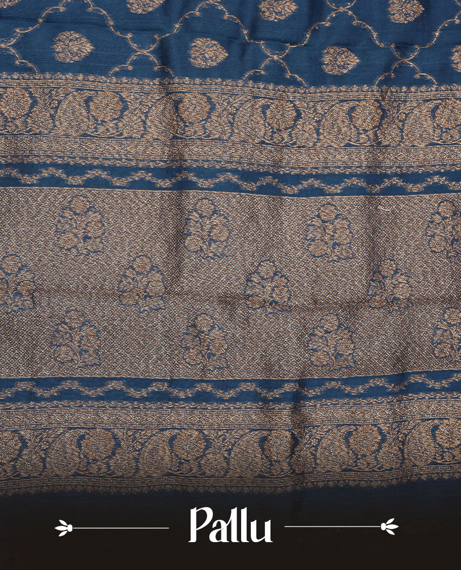 Crystal Teal colour semi Banaras saree with gold zari buta motifs, finished with a traditional gold zari border and pallu, paired with a matching blouse.