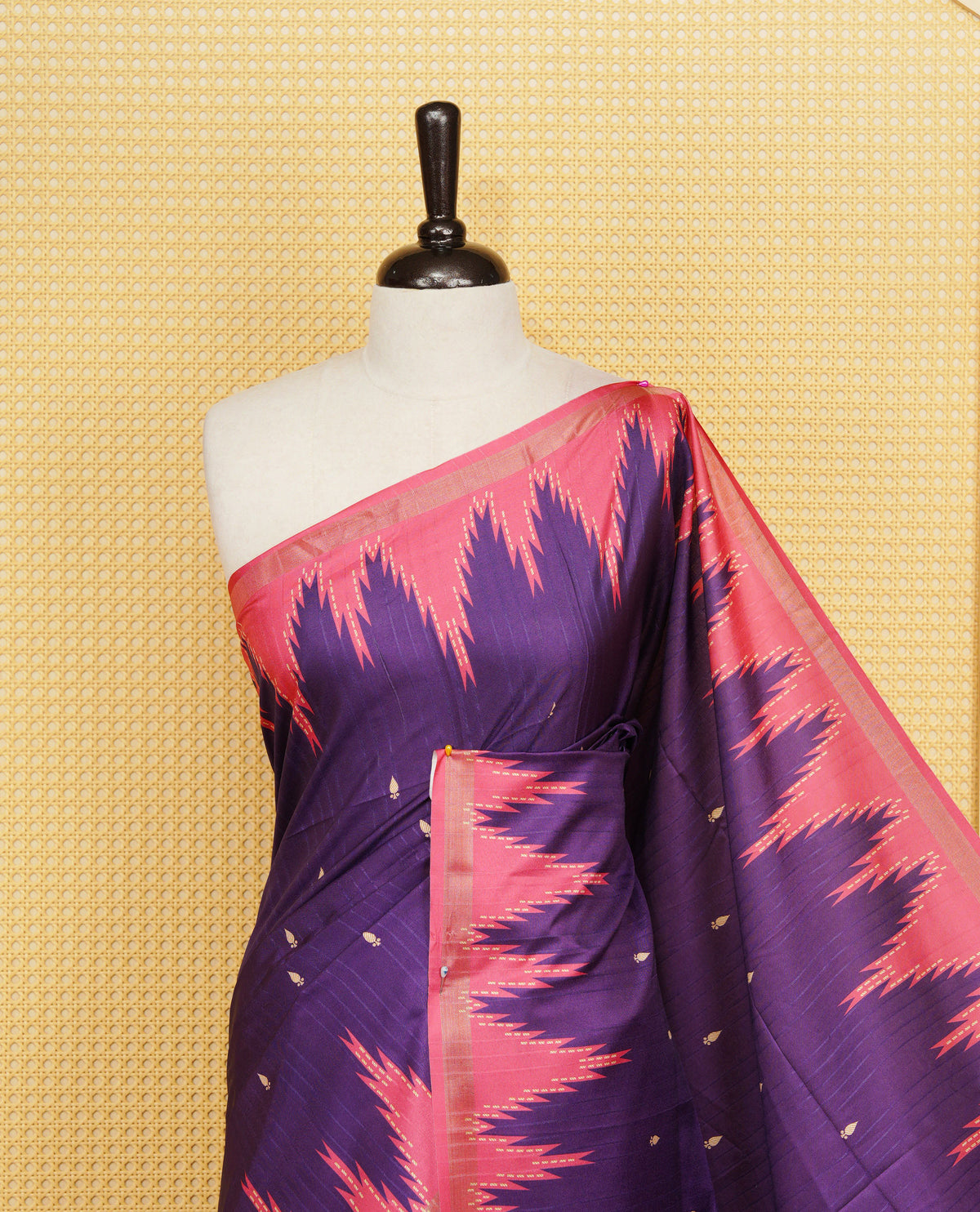 Violet And Peach Colour Kattan silk saree featuring buttas all over the body, a temple-designed border &  a contrasting striped pallu with tassels. Paired with a matching contrast-striped blouse piece.