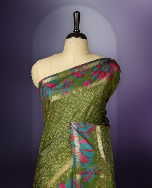 Green colour saree enhanced with a vibrant golden border and floral print pallu, adorned with intricate teal and pink floral prints on the body & comes with a matching blouse.