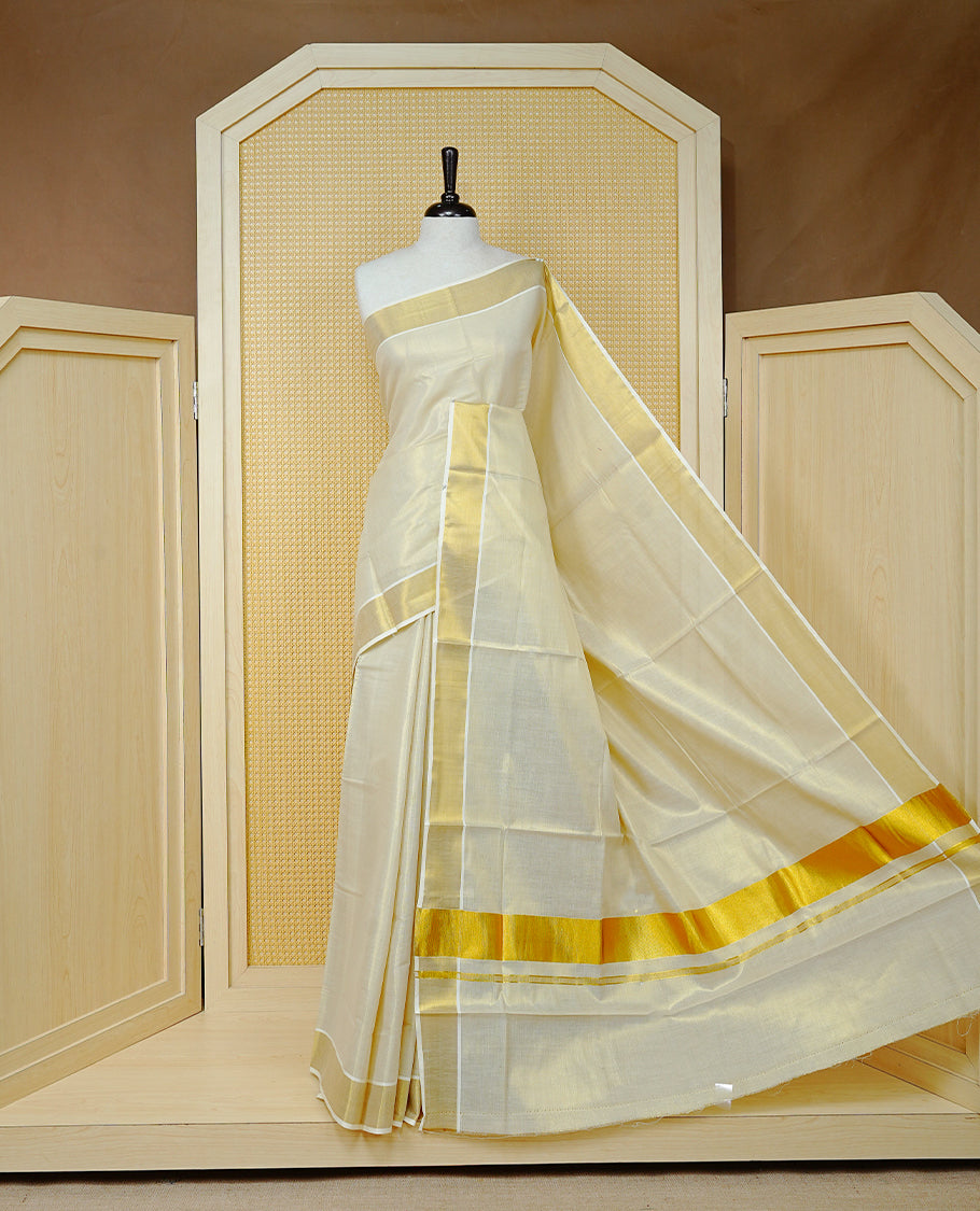 Cream Colour Tissue  Kerala Saree Featuring  Plain  Body, Enhanced With A Gold Zari  Border, A Traditional Gold Zari Pallu, And A Matching Blouse Piece.