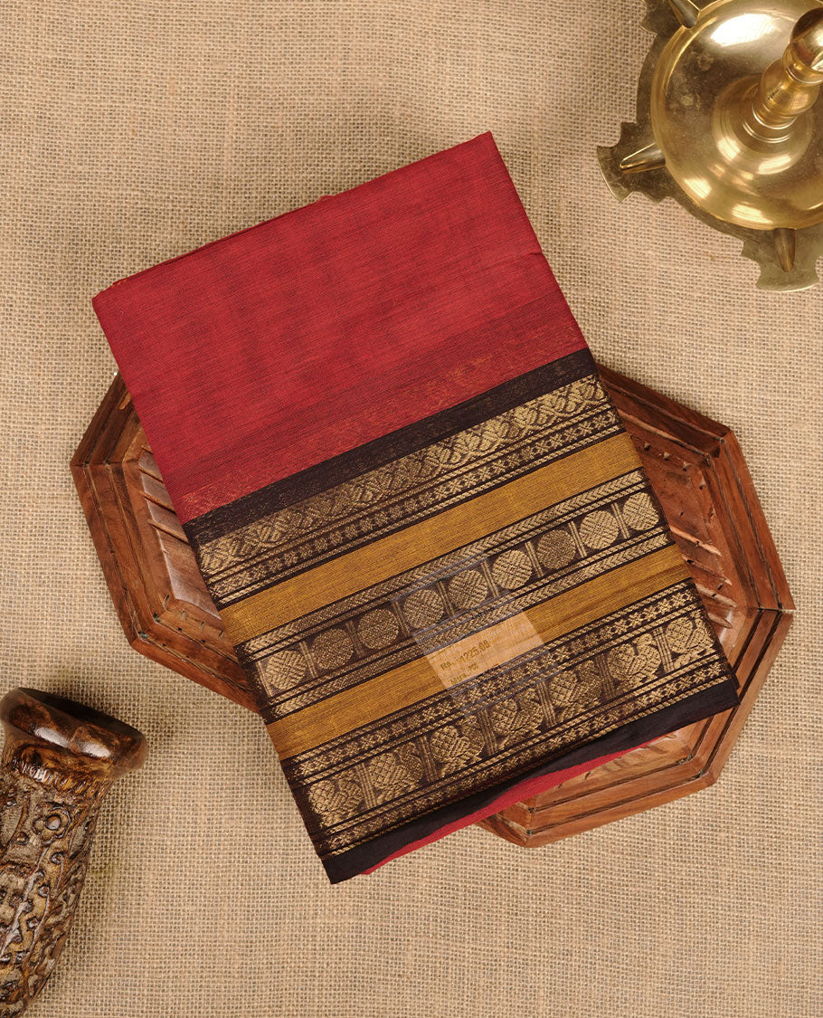 Maroon colour chettinad cotton saree featuring plain body, contrast chocolate brown and mustard colour with traditional gold zari border paired with matching blouse.