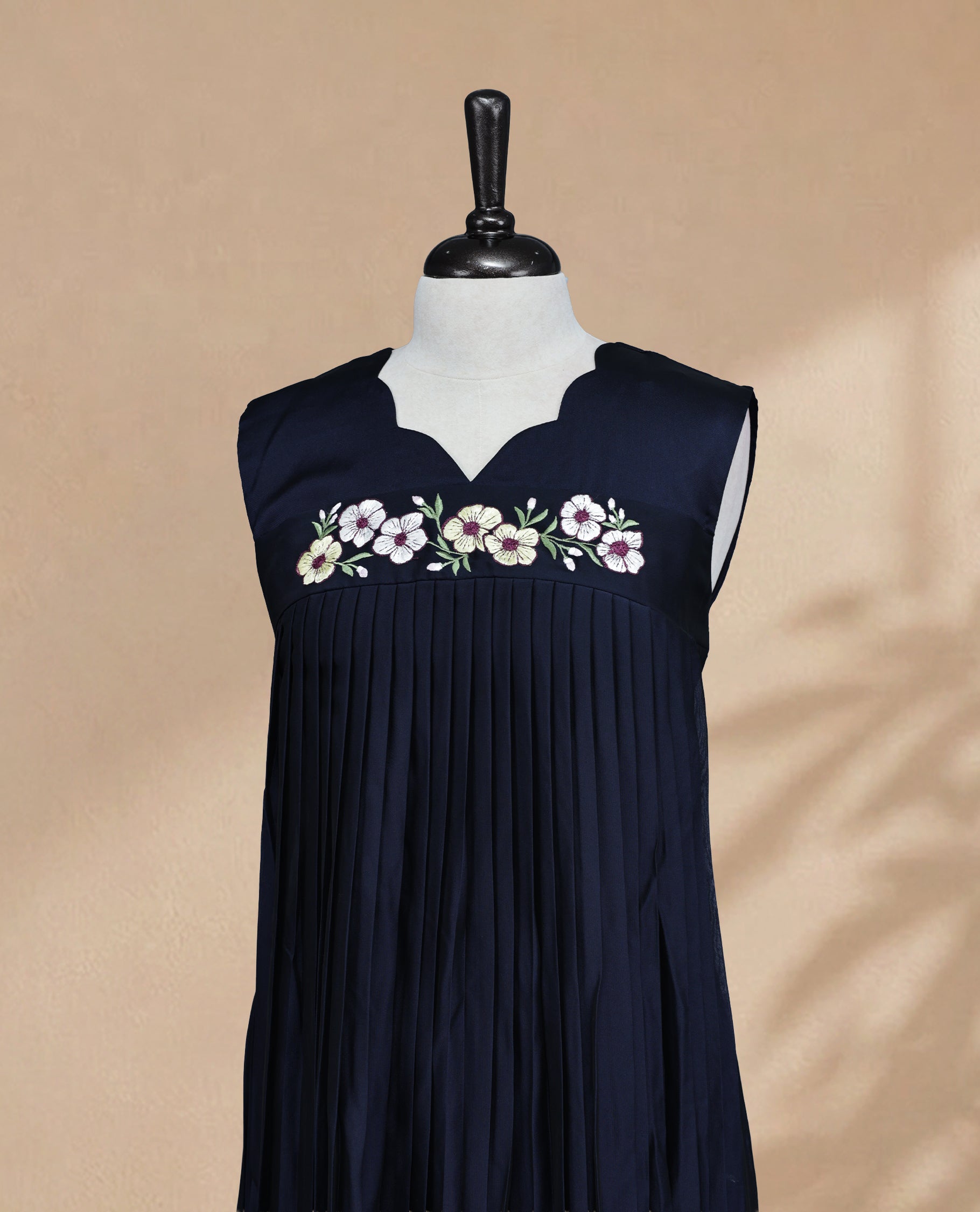 Navy Blue  Coloured Sleeveless Kurti Featuring a Designed Neckline, Floral Embroidery on the Body