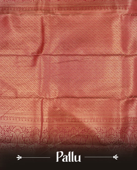 Maroon Colour Semi Wedding Silk Saree Featuring Gold Zari stripes With Chakkara & Peacock Buttas, Showcased with Green colour pipping With Traditional Border,  Paired With Matching Blouse Piece.
