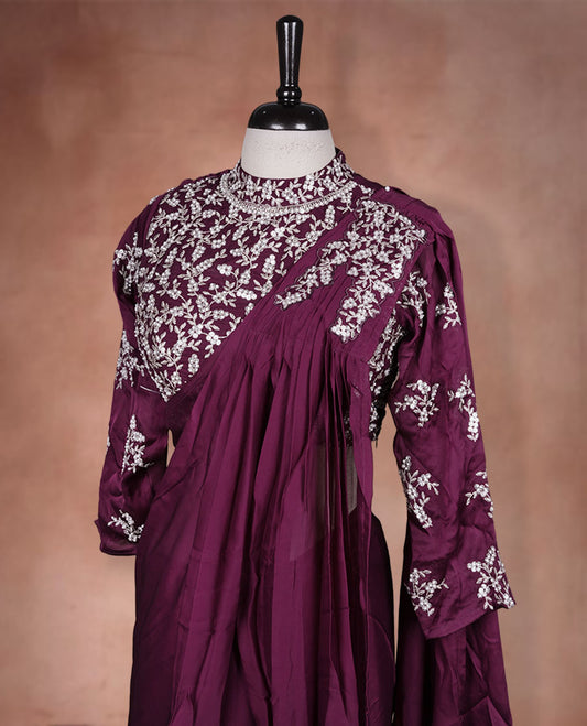 Wine colour ready to wear saree Fearturing intricate silver embroidery on the pallu, paired with a beats and thread embroidered matching blouse.