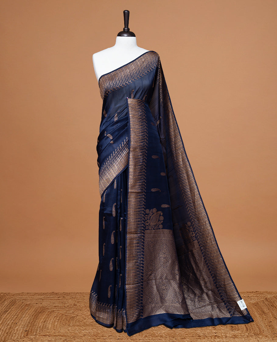 Navy Blue colour Semi Banaras Tussar Georgette Featuring Gold zari Leaf pattern on body, Finished with Gold zari border and paired with matching blouse piece.