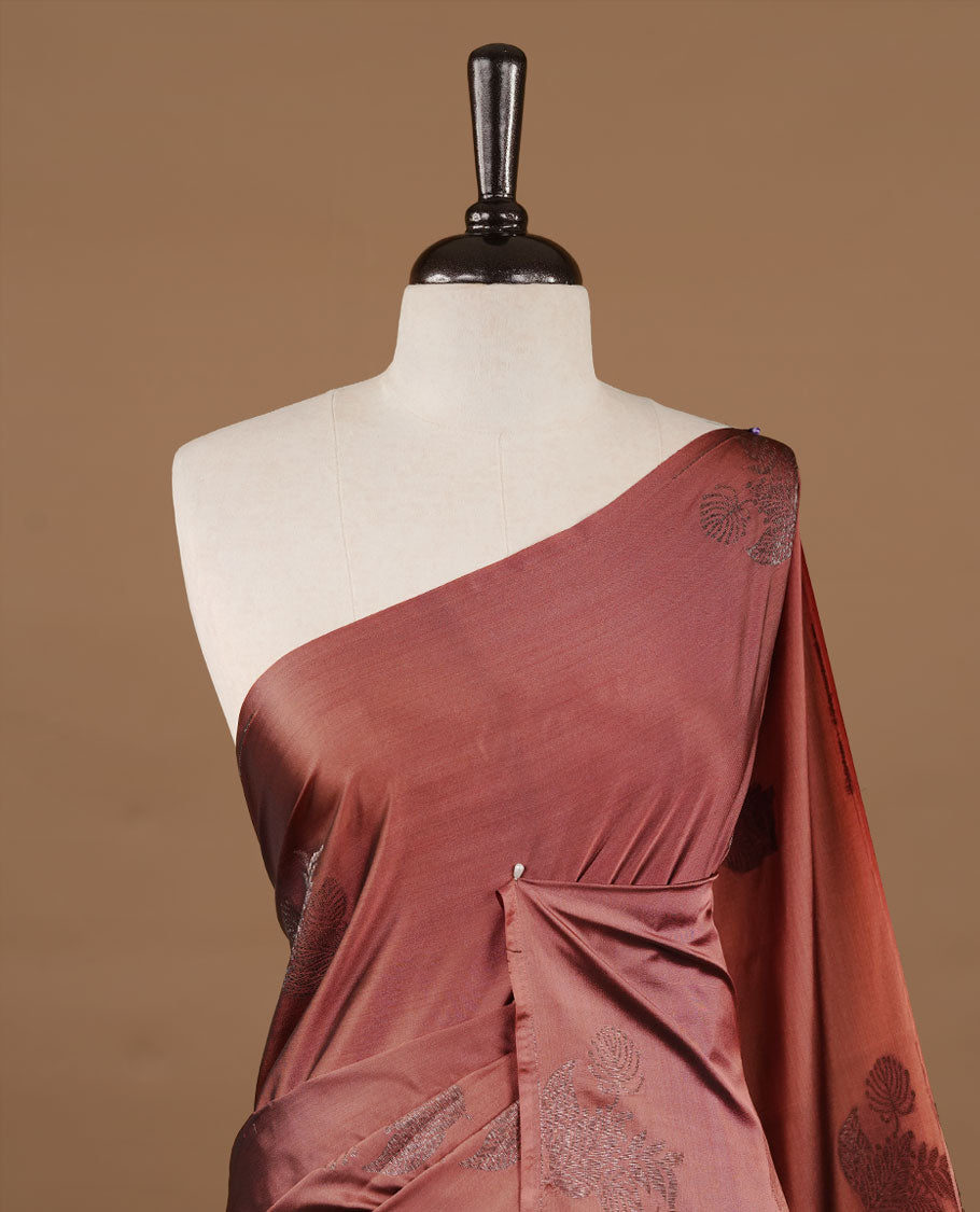 Brown colour soft silk saree features a sleek borderless design with intricate antique zari motifs, flowing into a striking contrast blue pallu and a matching blouse piece.