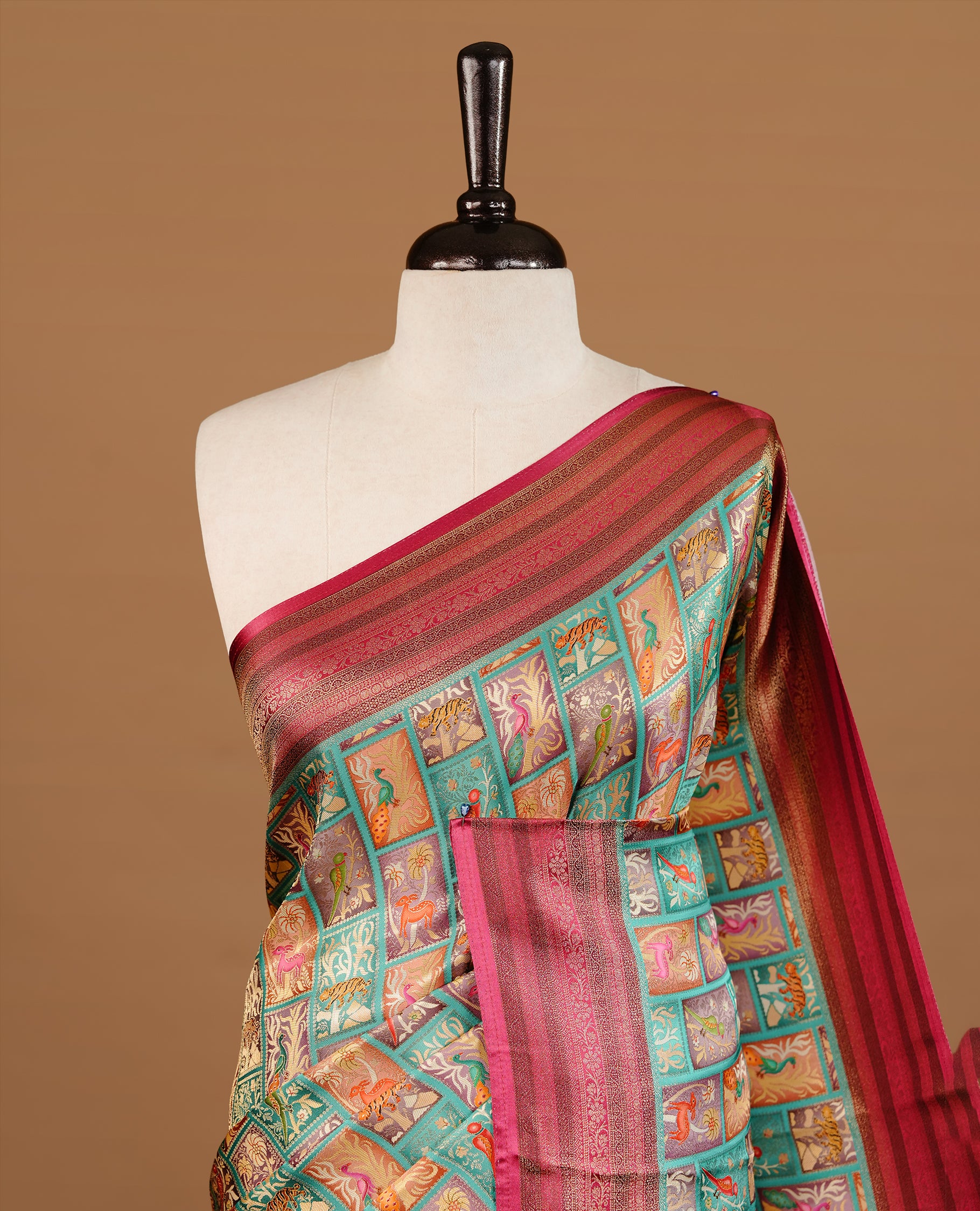Sea Green colour Pashmina Saree featuring multicolour woven square motifs across the body, enhanced with a contrast magenta zari border and rich woven pallu, paired with a matching blouse piece.
