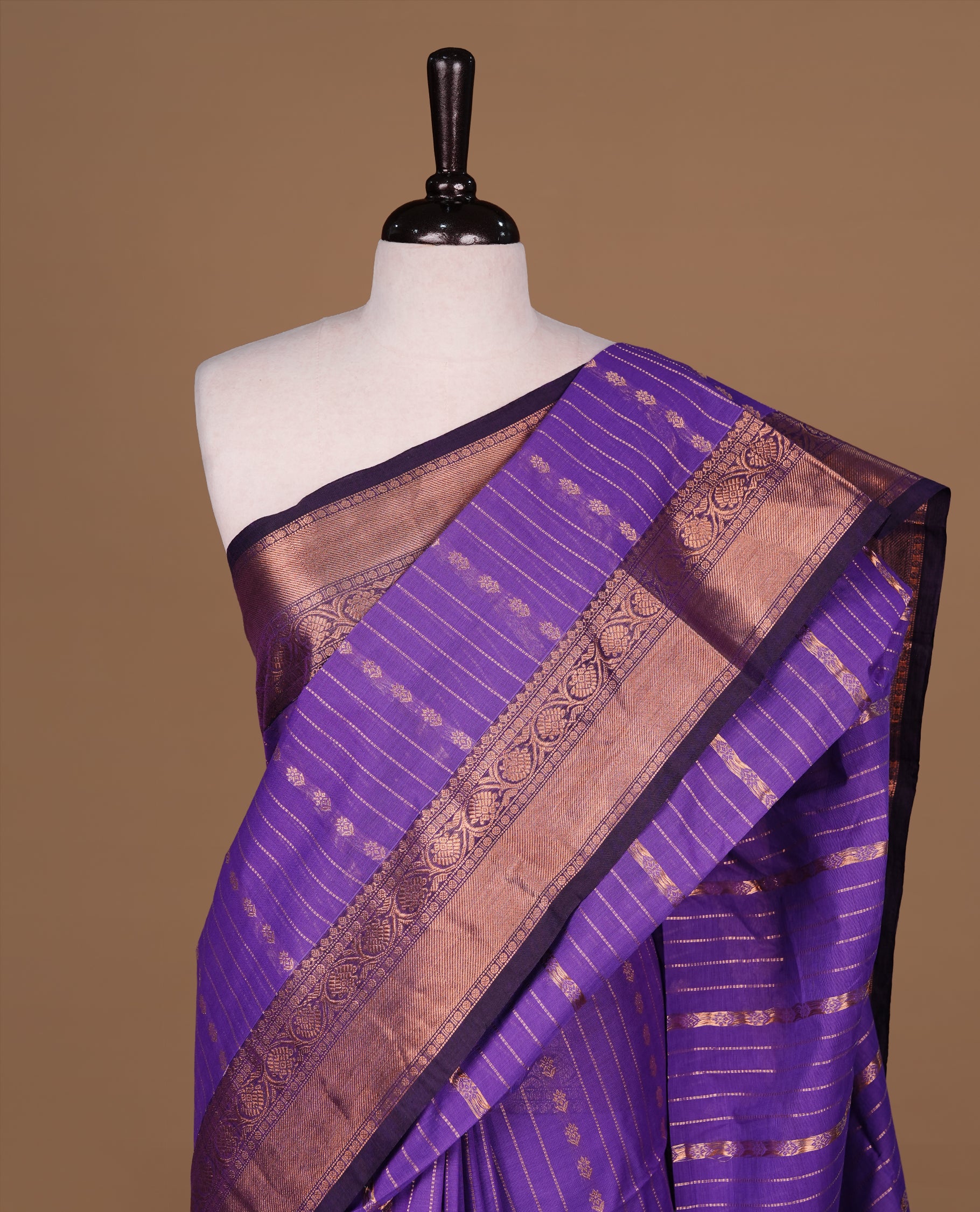 Violet Colour Chettinad cotton saree featuring Gold zari Stripes on body, complemented by contrast Dark purple colour with traditional border, paired with matching blouse piece.