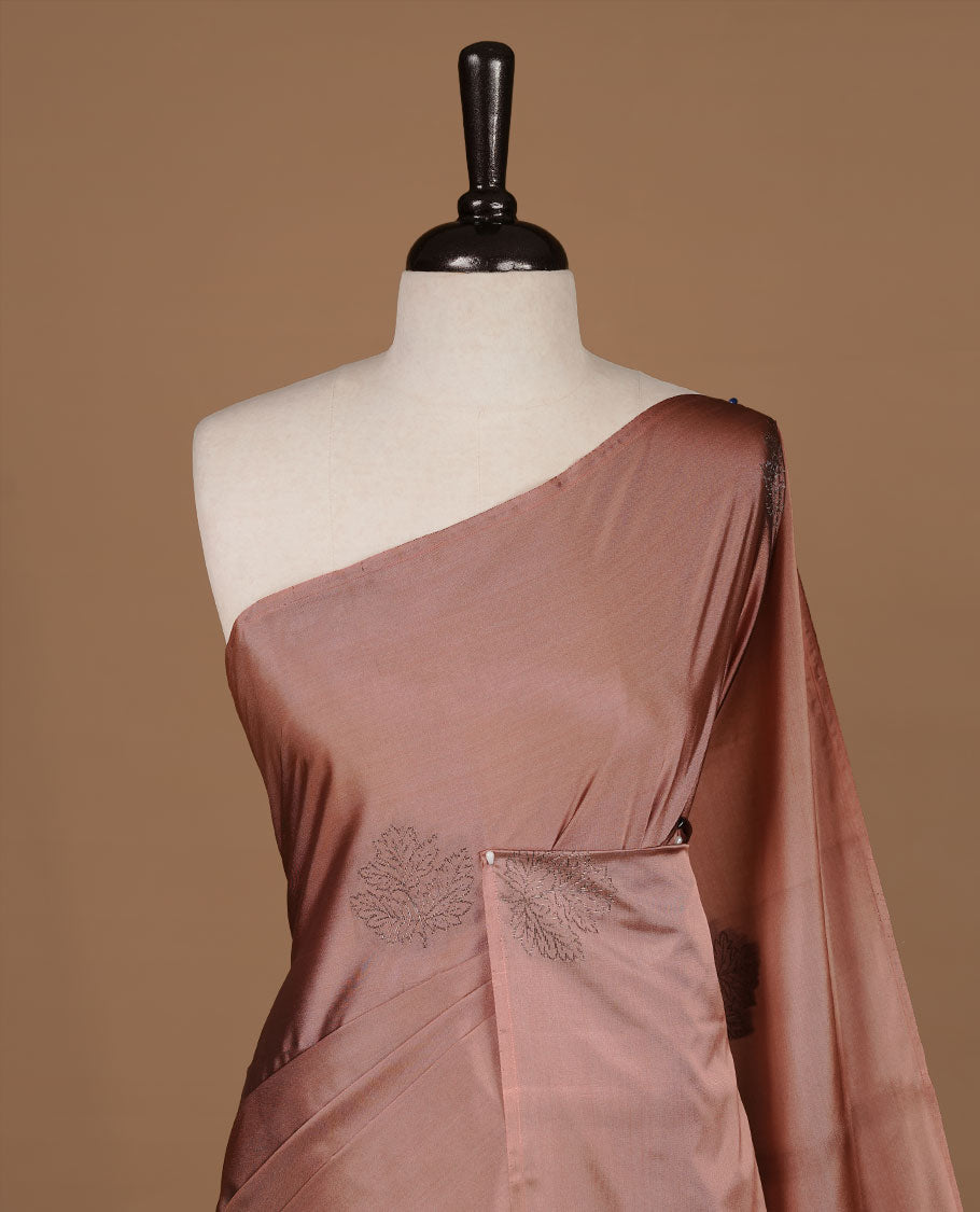 Dusty Cream soft silk saree features a sleek borderless design with intricate antique zari motifs, flowing into a seamless self colored pallu and a matching blouse piece.