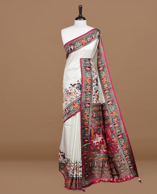 Off white Pashmina silk saree features a minimalist plain body beautifully contrasted by a vibrant red border adorned with multi colored horse and floral kodi motifs, complete with a matching blouse piece.