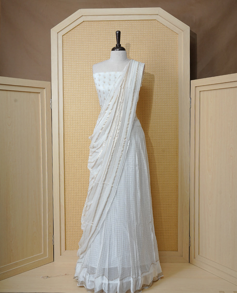 Off white colour Semi stitched dhavani set featuring Gold zari check pattern with Self colour border skirt, paired with matching blouse & dupatta.