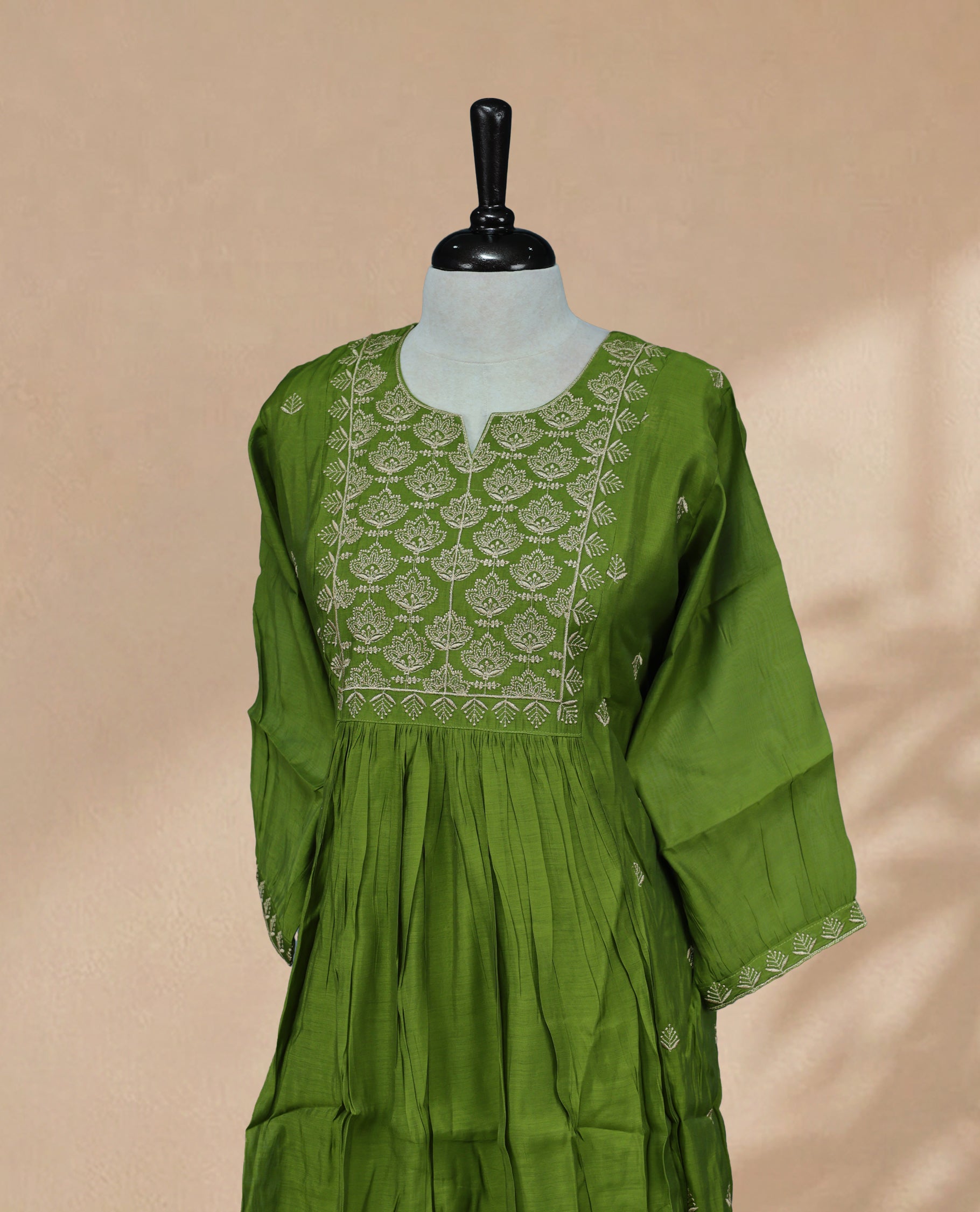 Green  kurti featuring a classic U-shaped neckline, Cream Colour  Floral Embroidery Work on the body, and sleeves.