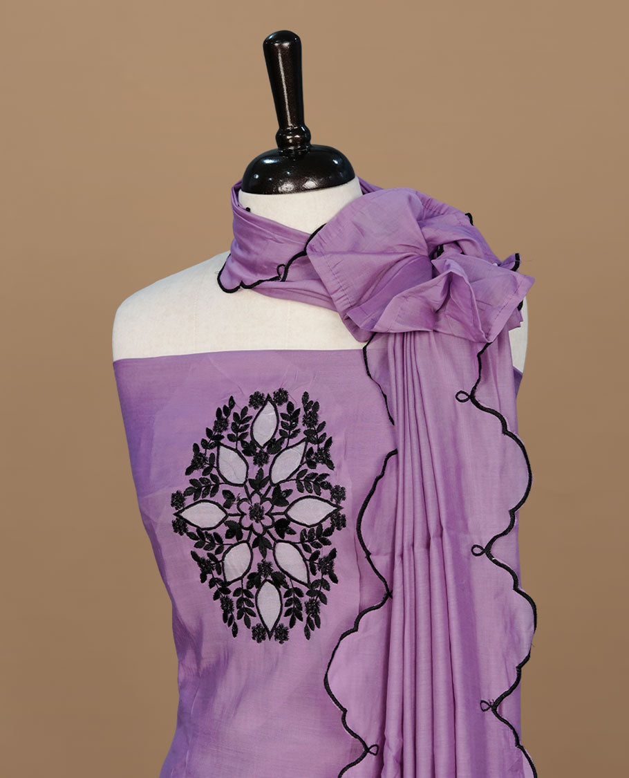Pastel purple colour churidari material featuring black thread pattern on body, paired with matching bottom and dupatta