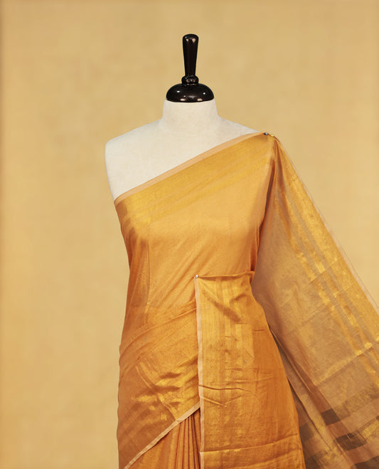 Gold colour Semi Tissue Silk saree featuring Elegant plain body, Enhanced with Gold tissue Border & Striped Pallu & beautiful Tassels for Elegant Prefect Look.