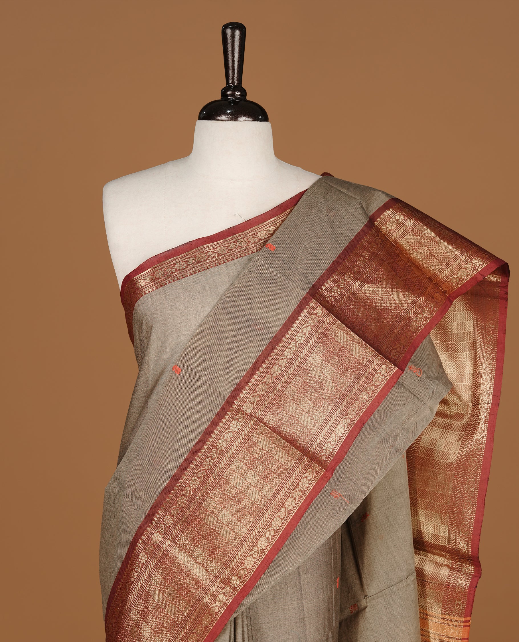 Grey colour Chettinad cotton saree featuring motifs on body , complemented by contrast Maroon colour with zari border, comes with matching blouse piece.