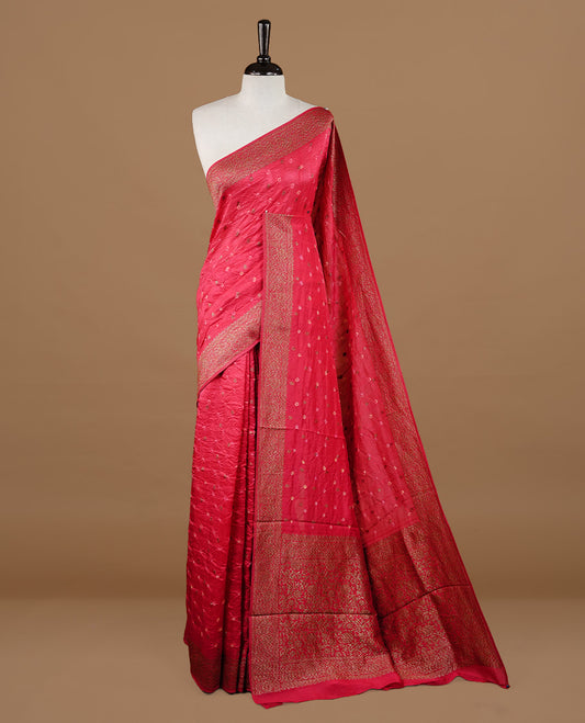 Red colour Banarasi Bandhani silk saree featuring intricate antique zari circle Buttas across the body, complemented by an elegant antique zari border. Comes paired with a matching blouse piece