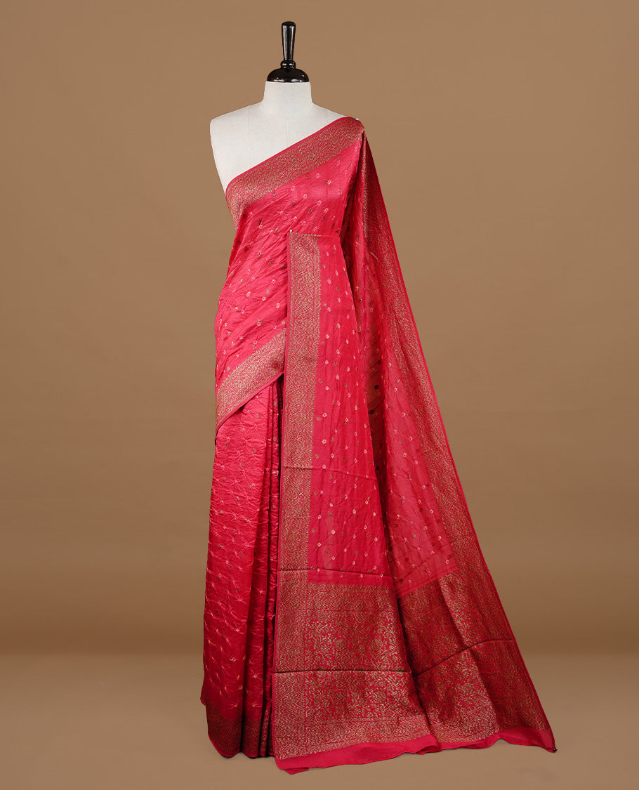 Red colour Banarasi Bandhani silk saree featuring intricate antique zari circle Buttas across the body, complemented by an elegant antique zari border. Comes paired with a matching blouse piece