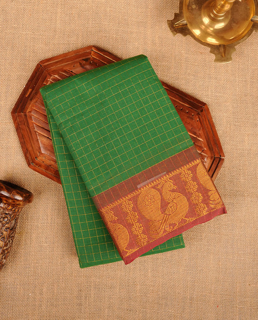 Green colour chettinad cotton saree featuring gold zari check patterned body, contrast brown colour with traditional gold zari border without blouse.