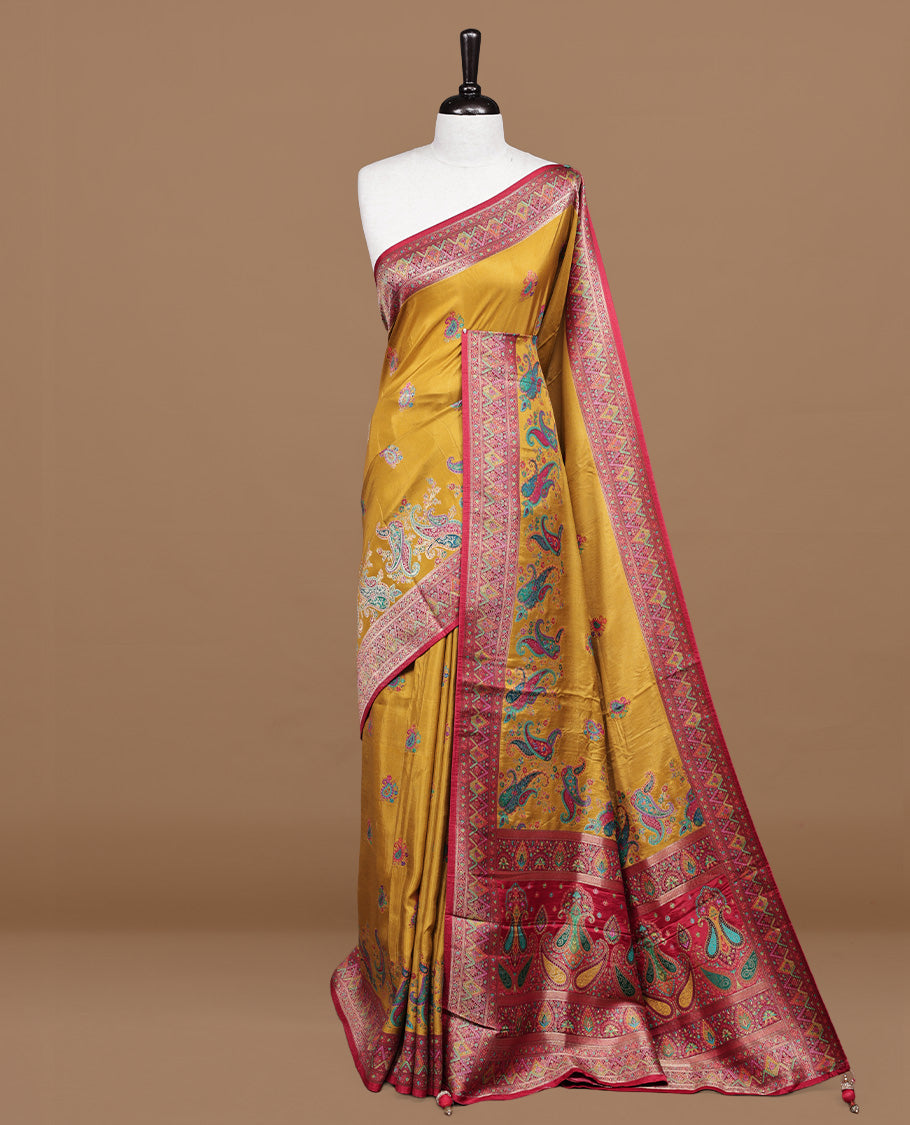 Mustard colour pashmina silk saree features all over motifs on body, contrast red with multi colour geometric border, paired with matching unstitched blouse blouse.
